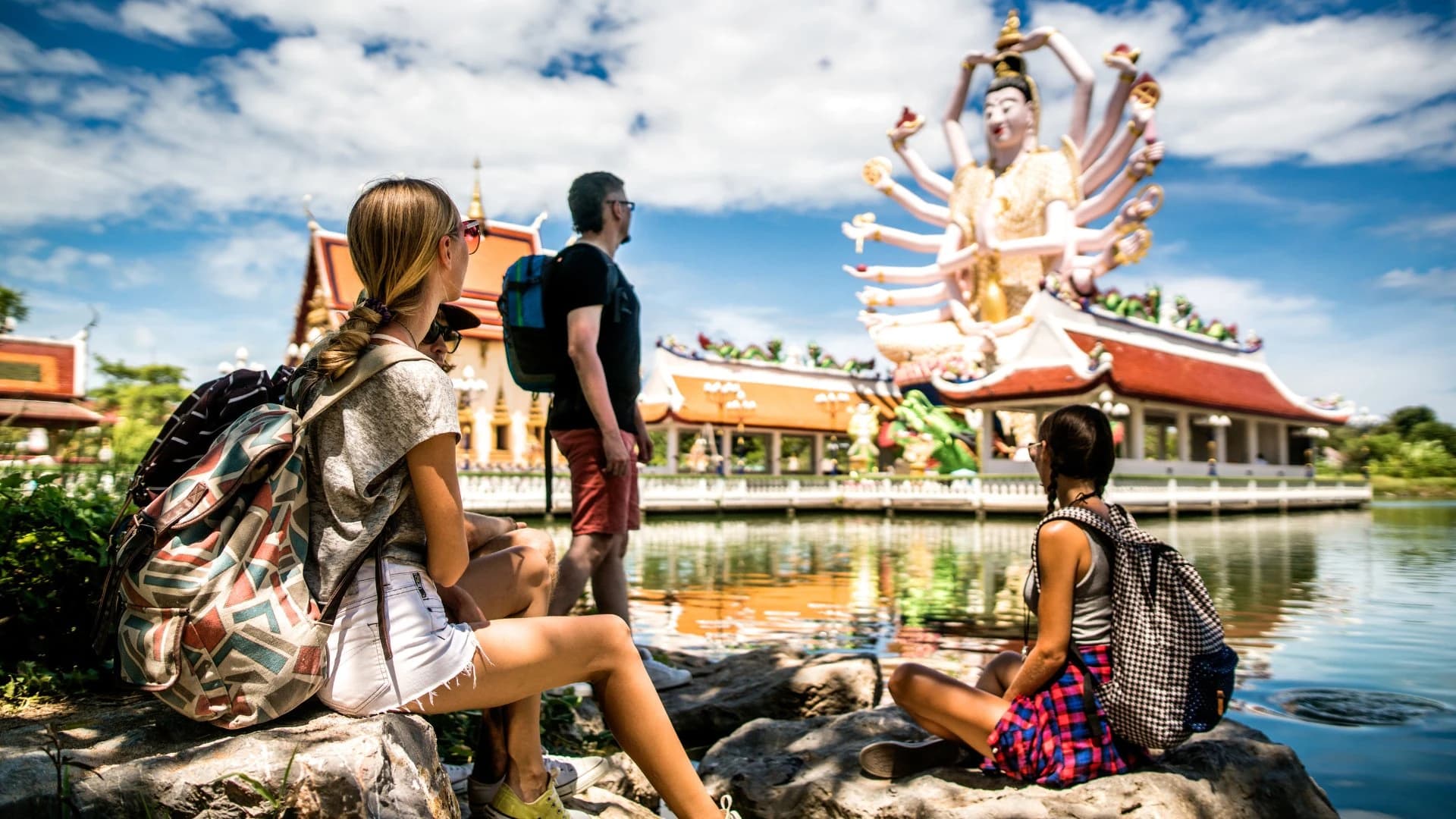 A small group of travellers at a temple in Thailand