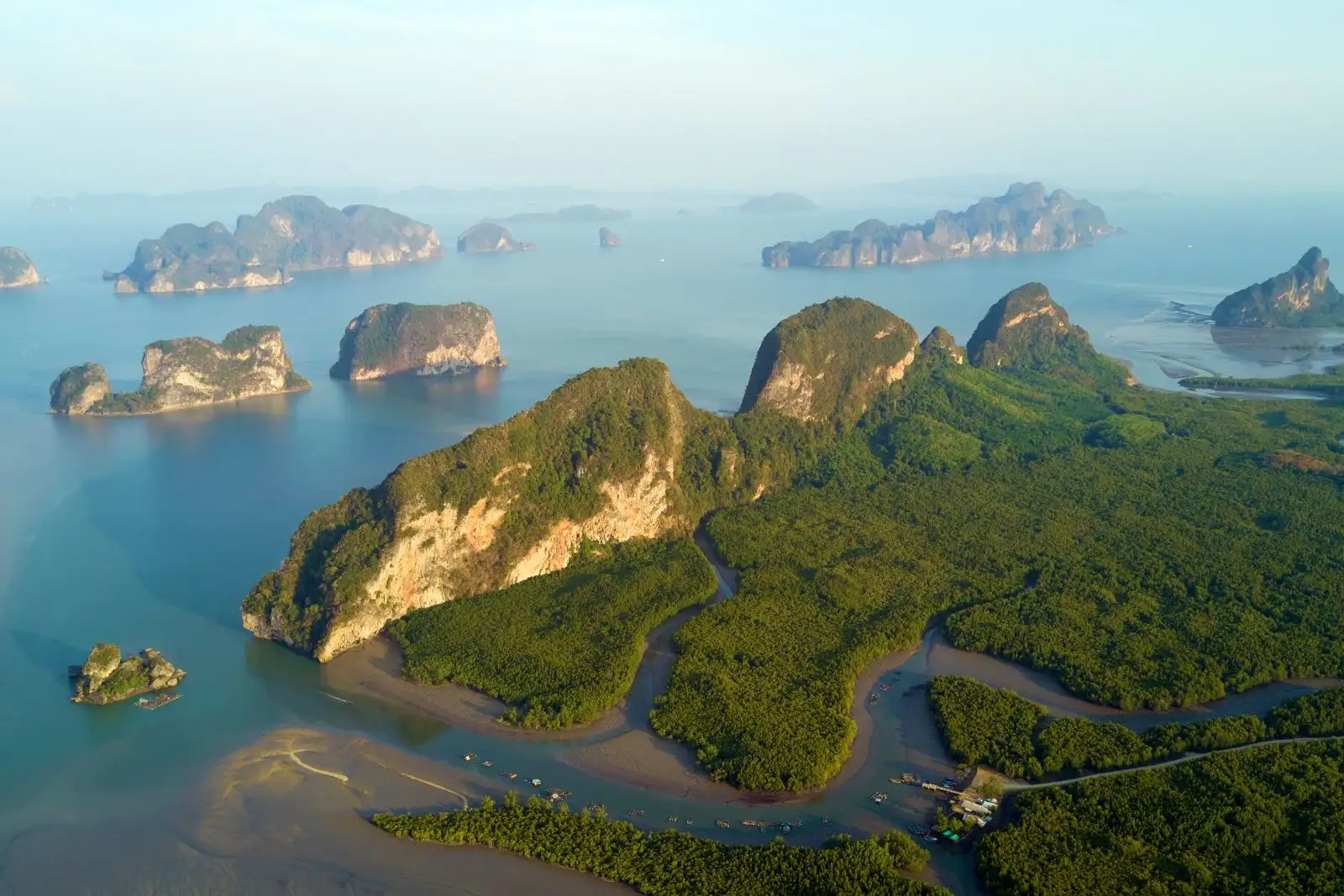 Aerial view of limestone cliffs rising from turquoise water in Phang Nga Bay, Thailand