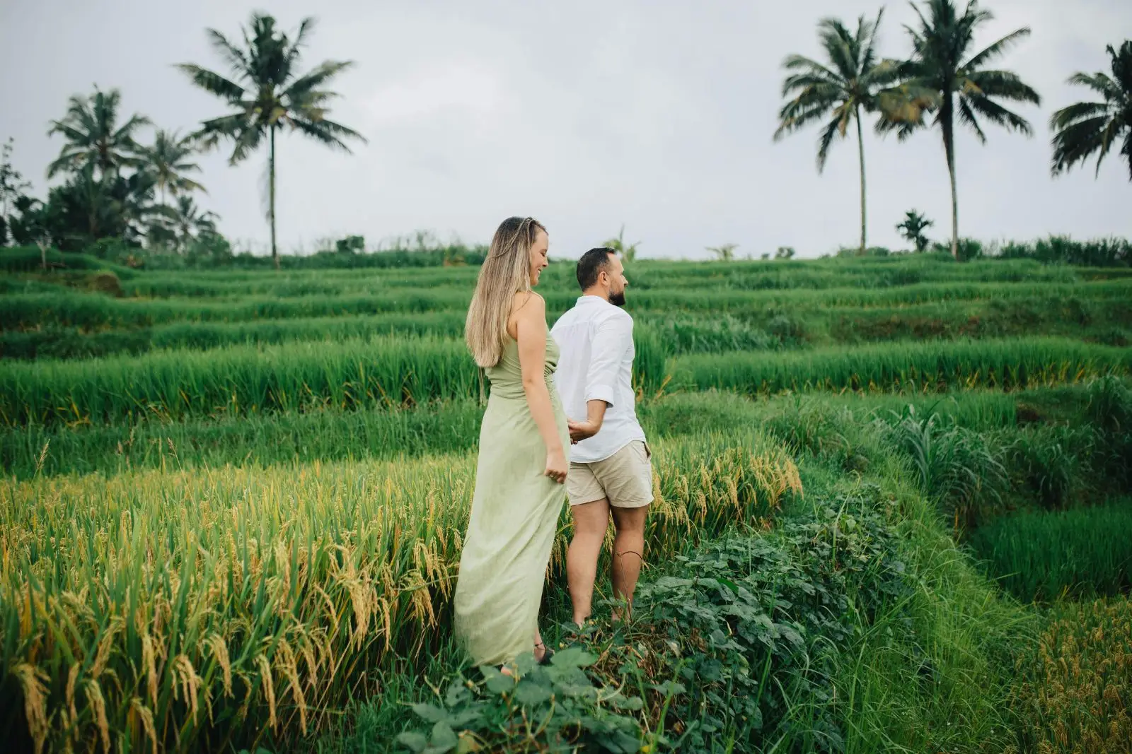 A couple walking the rice terraces above Ubud, Bali
