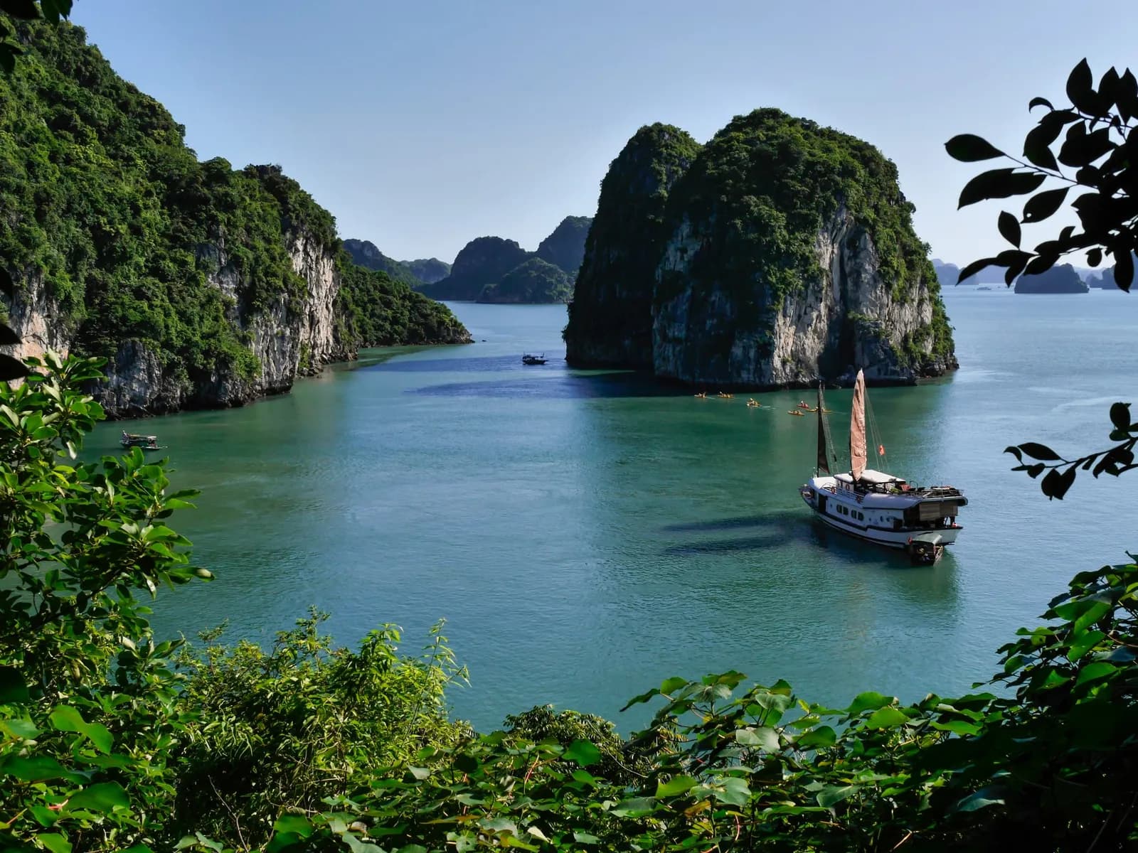 A traditional junk boat among the limestone islands of Ha Long Bay, Vietnam