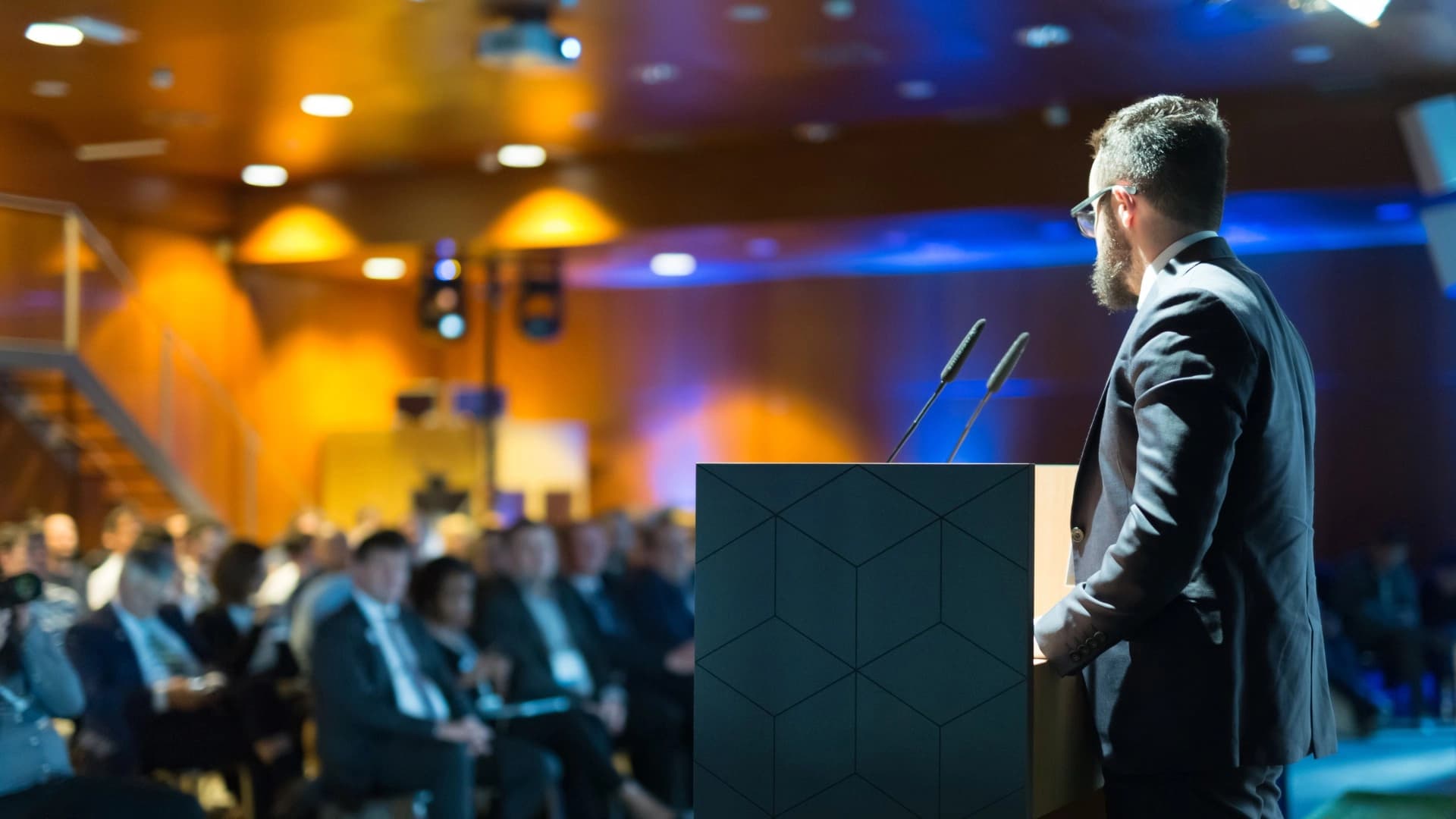 A speaker addressing delegates at a MICE event