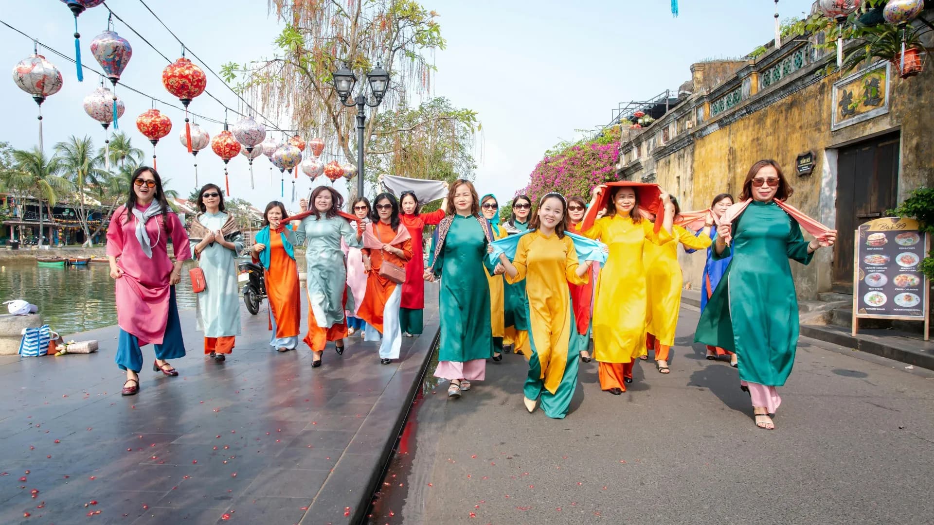 Vibrant traditional dress parade in Hoi An, Vietnam