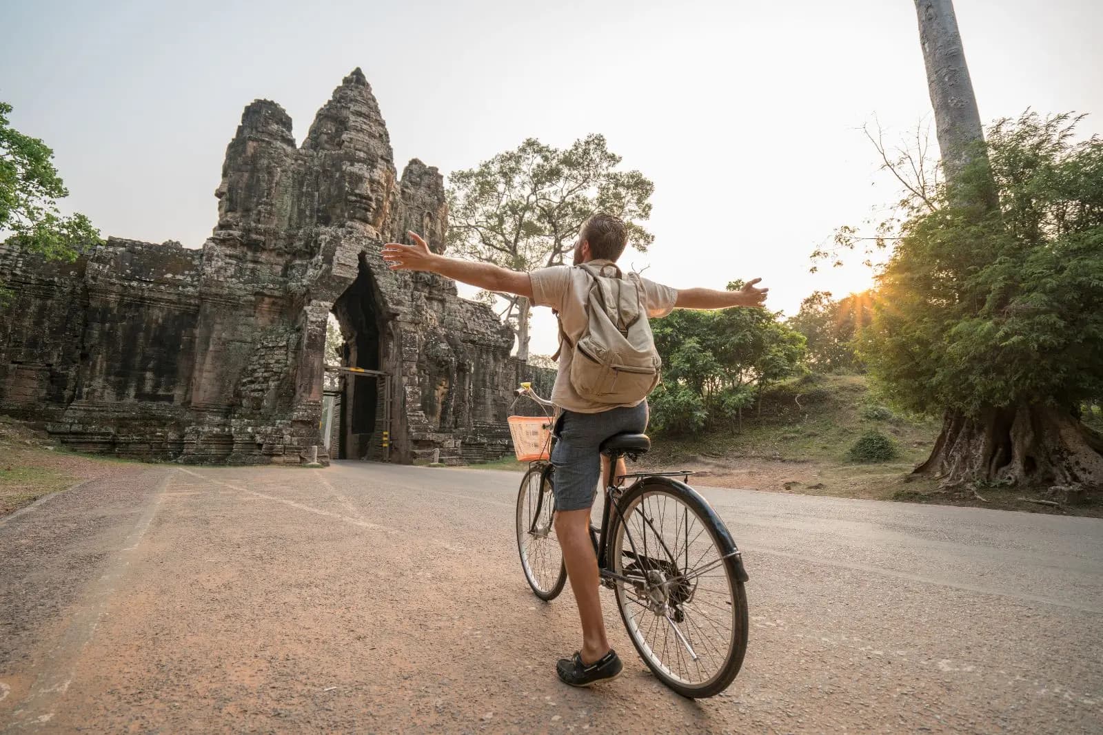 Cyclist in an ancient temple complex, Cambodia