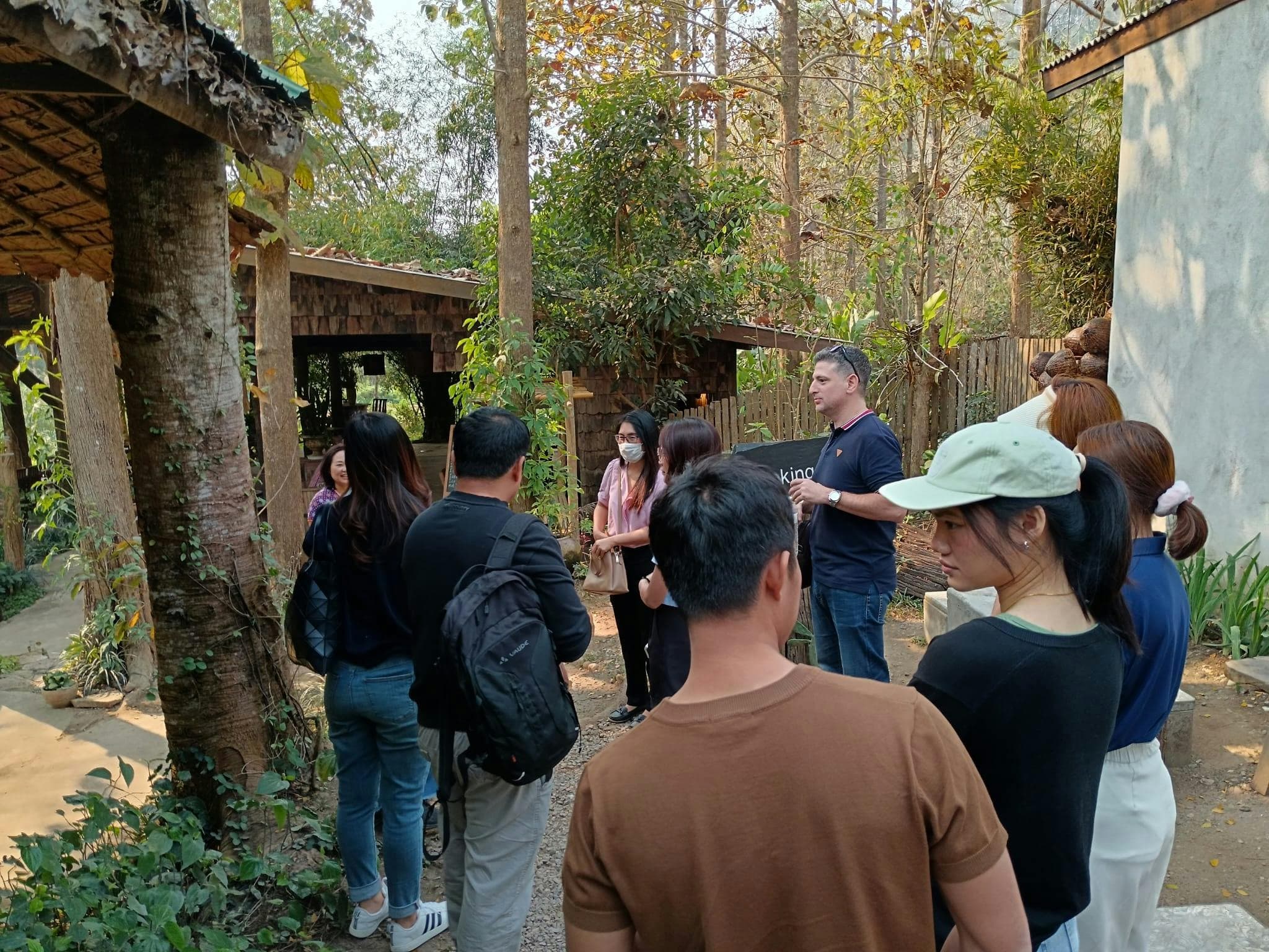 DMC Connect team leading a group tour through a forest homestay